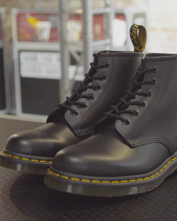 Black boots with yellow tag best sale